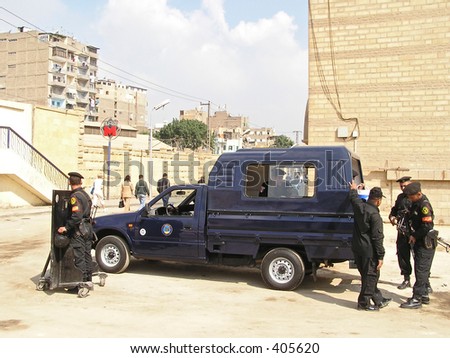 Egyptian policemen checking their guns in high security area of Cairo, Egypt.  Egyptian policemen gave permission  to take pictures and always enjoyed it.
