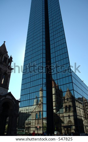 Hancock tower, a stark contrast with the 19th century romanesque Trinity Church across the street which reflects on its glass wall, Boston, Massachusetts
