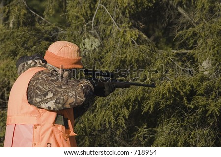 Senior hunter aiming a deer in his sight, Quebec, Canada