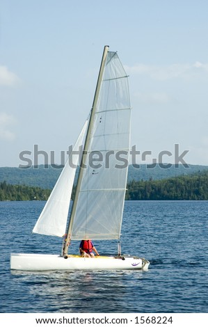 senior  woman sailing on a white  catamaran