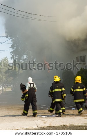 Firefighters fighting  burning building in Quebec country, Canada