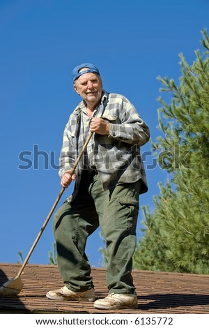 senior man cleaning the roof