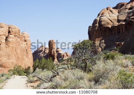 dirt road to Devils Garden on Arches National Park with mountains on back, Utah, USA