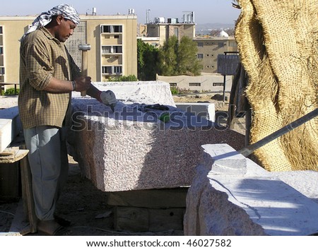 ASWAN - MARCH 1: Stone-cutter of granite prepares for an international symposium March 1, 2005 in Aswan, Egypt.