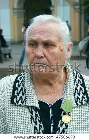 ST-PETERSBURG, RUSSIA - MAY 9: Senior woman - veteran of the second world war on a holiday of Victory and her medal \