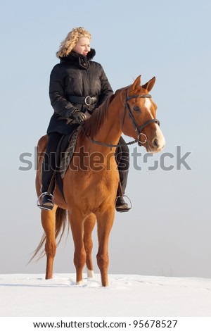 Girl riding Russian Don horse at winter day