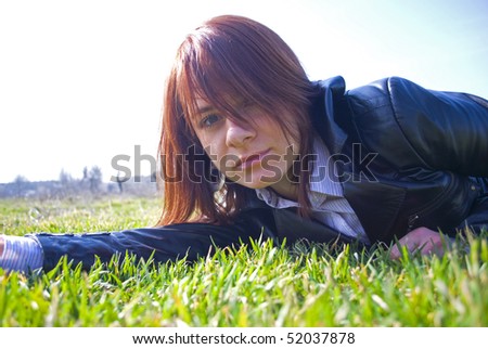 The photograph of dreamy girl lying on a spring lawn