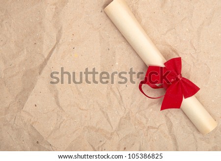 Diploma with red ribbon on old paper