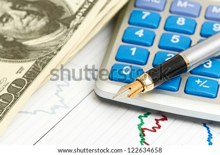 Pen, calculator and dollars