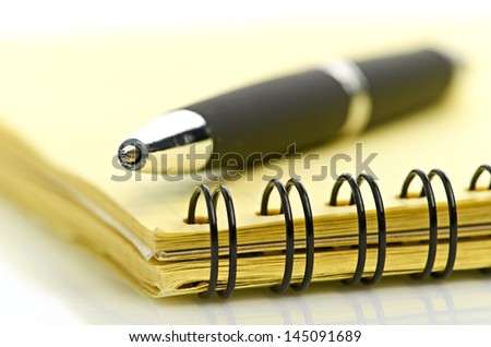 notepad and pen isolated on white background