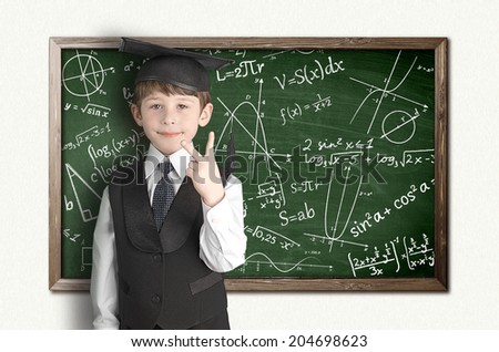 boy near blackboard with formulas
