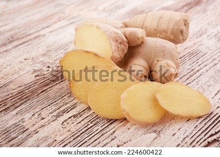 Ginger root sliced on wooden table