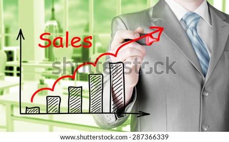 business man drawing graph of sales