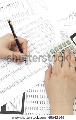 Close-up image of a businessman\'s hands calculating profit and analyzing stock charts