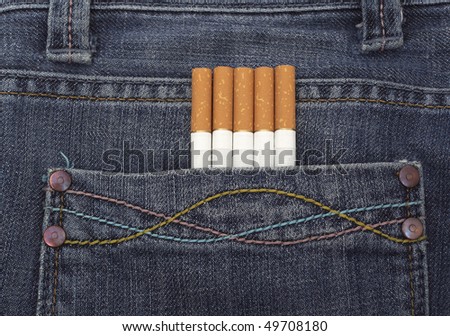 close up of a blue jeans pocket with cigarettes coming out of it