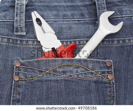 Toolkit of five items in a blue jeans pocket