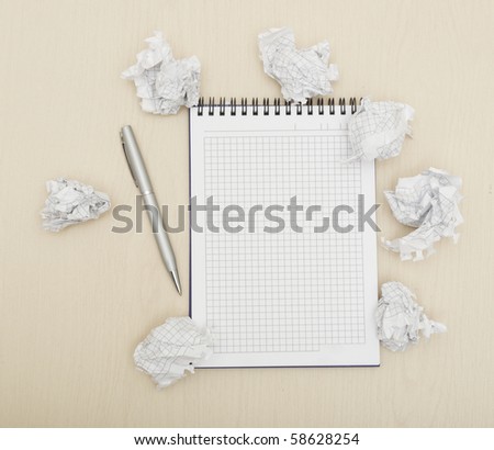 Blank notepad with ink pen on wooden desk