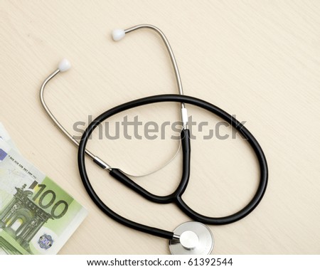Medical stethoscope and monetary denominations of euro, close up