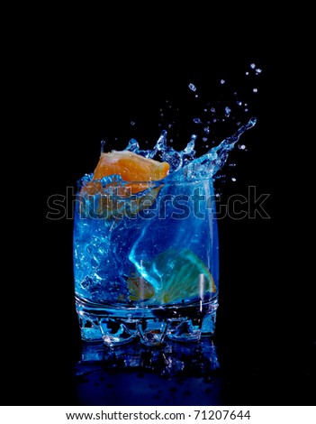 Orange in blue water splash on black background