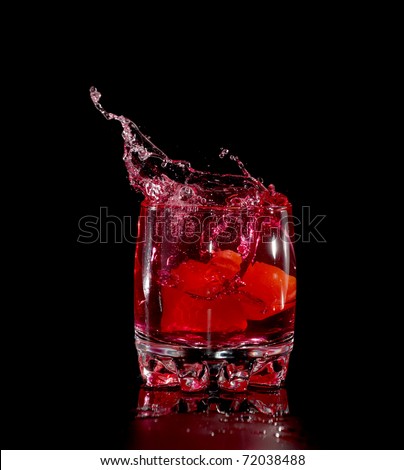 red splash in glass from ice cube