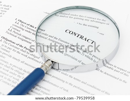 blue Magnifying Glass and document close up