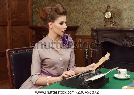 Pinup beautiful young woman in vintage interior reading a book and prints on an old typewriter