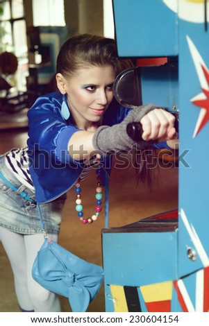 Young woman in USSR 80s style posing in a museum of gaming machines in Moscow