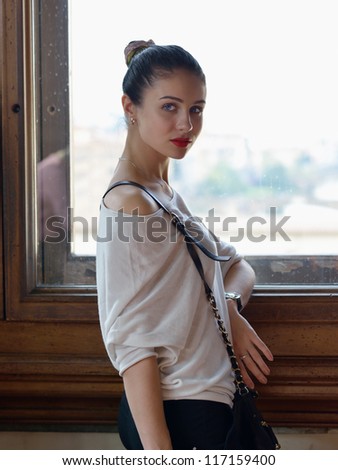 Portrait of attractive young woman in spanish style near bright window