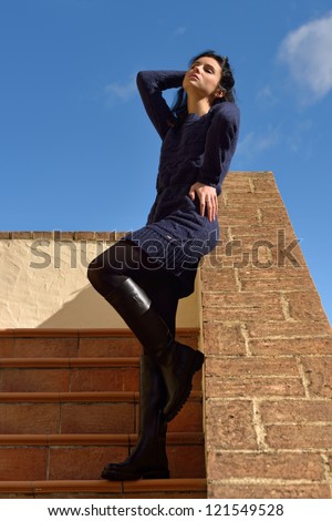 Sensual beautiful girl staying  on the stairs of the old house under bright sun. Tuscan, Italy