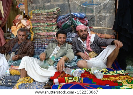 SANAA, YEMEN - MARCH 6: Three unidentified men sell carpet on Mar 6, 2010 in Sanaa, Yemen. Open markets play a central role in the social-economic life of one of the poorest countries in the  World