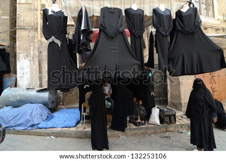 SANAA, YEMEN - MARCH 6: Unidentified men sell abaye for women on Mar 6, 2010 in Sanaa, Yemen. Open markets play a central role in the social-economic life of one of the poorest countries in the World