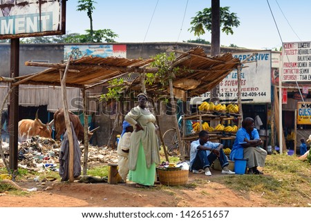 KAMPALA, UGANDA - AUG 26: Native people sell banana at local market on Aug 26, 2010 in slum of Kampala. Nearly 40% of slum dwellers have a monthly income of just 2,500 shillings Ã?Â¢?? less than a dollar