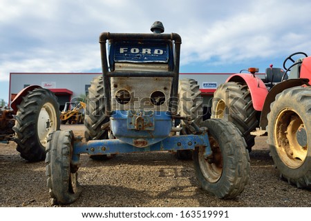 GIALOVA, GREECE - OCT 9: Old Ford tractor shown at a junkyard on oct 9 2013 in Greece. First Ford tractor was made  in 1916. In 1991 Ford sold its tractor division and stop using the Ford name by 2000