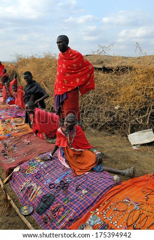 MASAI MARA, KENYA - AUG 23: Local sellers from Masai tribe offer goods in the market, on Aug 23, 2010 in Masai Mara. Traditional handmade accessories very popular souvenir from Kenya for most tourists
