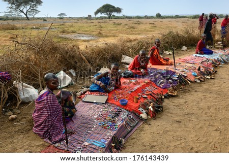 Masai Mara, Kenya - Aug 23: Local Sellers From Masai Tribe Offer Goods In The Market, On Aug 23, 2010 In Masai Mara. Traditional Handmade Accessories Very Popular Souvenir From Kenya For Most Tourists