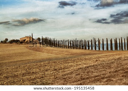 Idyllic rural Tuscan landscape with old farmhouse near Pienza at sunset, Vall d\'Orcia Italy, Europe. Filtered. Vinage effect applied