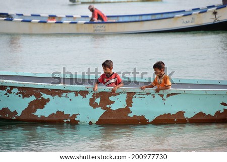 SOCOTRA, YEMEN - MAR 08, 2010: Unidentified Yemeni boys on a boat at  the Socotra island. Children on the Socotra Archipelago grow without education