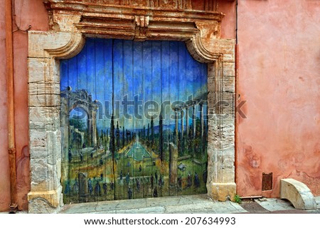 ROUSSILLON, FRANCE - JUL 07, 2014: Painting of French garden with ruins of Roman temple on door of old house. Roussillon ocher village is included in list of \