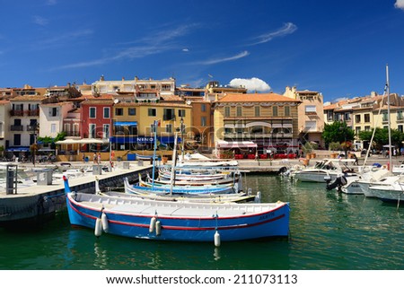 CASSIS, FRANCE - JULY 14, 2014: A picturesque tourist port in the south of France called Cassis. Cassis is a famous port where tourists charter boats to view the calanques.