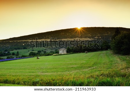 Stunning landscape with field and old farmhouse at sunset. Plateau of Sault, Provence, France