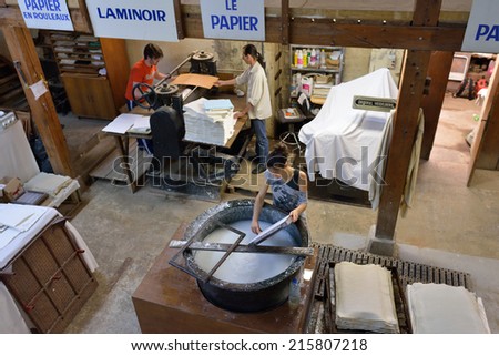 PROVENCE, FRANCE - JUL 8, 2014: Workers made a paper in medieval paper mill in Village of Fontaine de Vaucluse. Local manufacturing was founded in the 14th century
