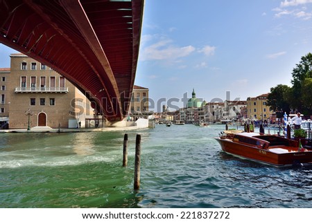 VENICE, ITALY - SEPT 21, 2014: View on the Grand Canal in Venice under the bridge of the Constitution at morning. The Grand Canal is the largest canal in Venice, Italy.