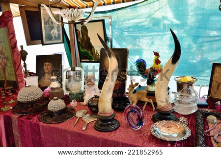 VENICE, ITALY - SEP 21, 2014: Old jewelry, accessories, toys, painting, arts, etc for sale at Venice flea market. This flea market serves the professional antique dealers.