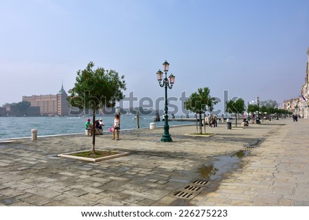 VENICE, ITALY - SEPT 21, 2014: View on the Venice San Marco seafront at morning.Tourists from all the world enjoy the historical city of Venezia in Italy, famous UNESCO World Heritage Site
