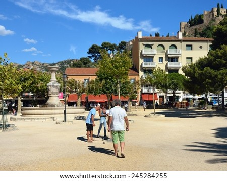 CASSIS, FRANCE - 14 JUL, 2014: Petanque players shown on central square of Cassis, French Riviera. Most popular game for local people in all season