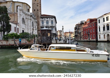 VENICE,ITALY- SEPT 24, 2014: A specific water taxi on The Grand Canal in Venice. The canals serve the function of roads, and almost every form of transport is on water or on foot