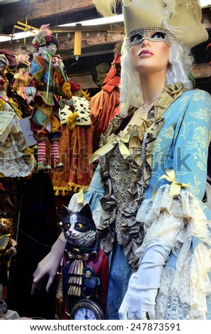 VENICE, ITALY - SEPT 21, 2014: Venice shop window, Venetian carnival costumes - symbol of Venice.  Tourists from all the world enjoy the historical city of Venezia in Italy, UNESCO World Heritage Site