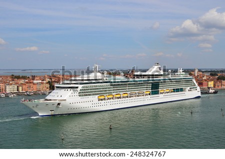 VENICE, ITALY - SEPT 24, 2014: The luxury cruise ship shown in the Venetian Lagoon at morning. More than 10 million tourists visit Venice every year