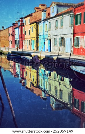 Colorful houses on the famous island Burano. Venice and the Venetian lagoon are on the UNESCO World Heritage List.  Filtered image, vintage affect applied. Soft effect and grunge