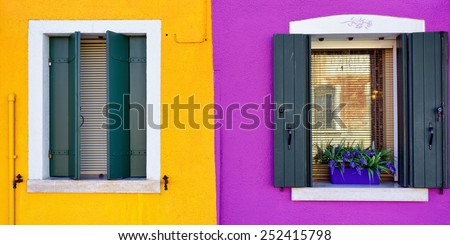 Burano island, Venice. Windows with green shutter on colorful wall. Colorful houses island and landmark of Veneto region, Italy